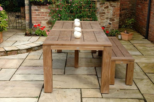 salon-de-jardin-en-teck-une-table-et-une-banquette-dans-une-cour-en-style-ancien