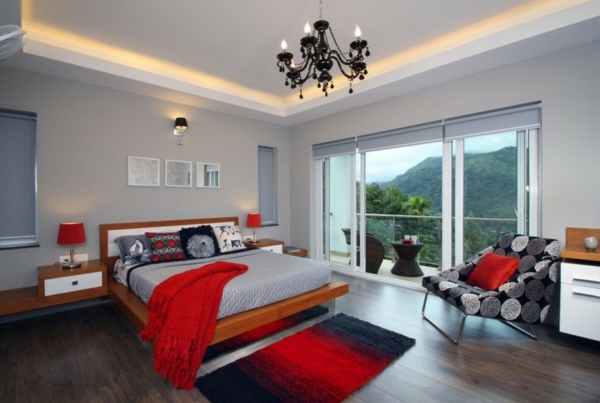 décoration-chambre-à-coucher-accents-en-rouge-lit-coussins-lampe