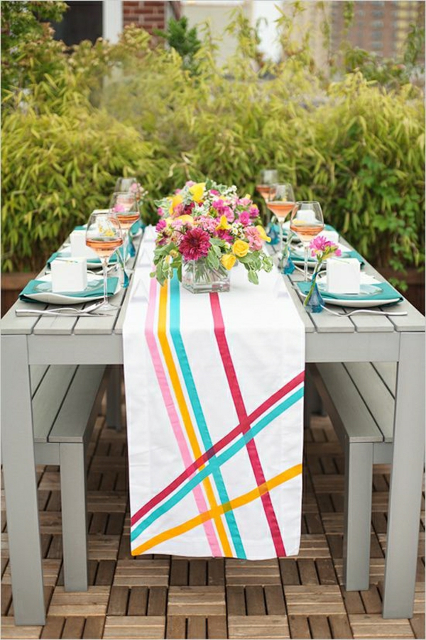 chemin-de-table-coloré-bleu-jaune-blanc-violet-rose-table-en-bois-gris-de-jardin