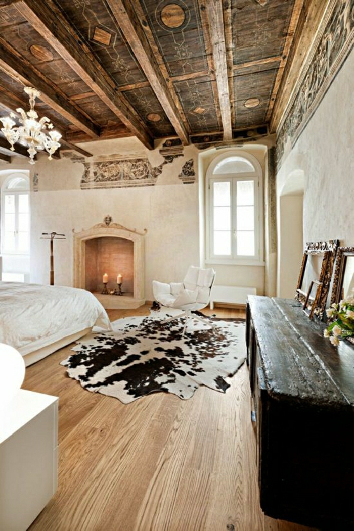 1-chambre-a-coucher-intérieur-rustique-meuble-en-bois-tapis-peau-de-vache-blanc-noir