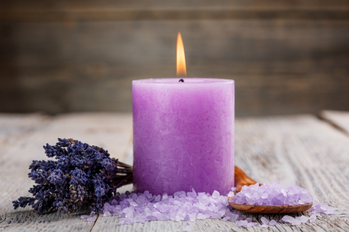 Spa setting with candle, salt and dried flower