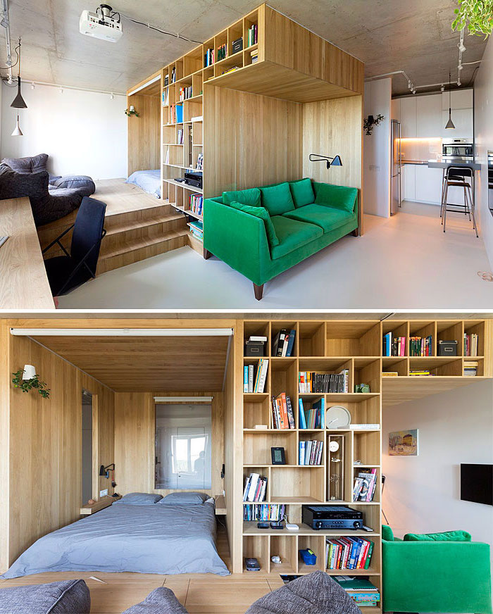 idée déco studio avec lit dans une niche de vois meuble bibliotheque, canapé vert foncé, bureau bois, décoration appartement étudiant avec kitchenette studio blanche