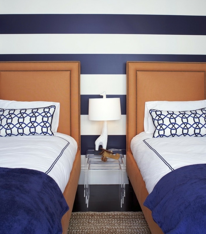 deco-chambre-adulte-bleu-mur-a-rayures-bleu-et-blanc-couverture-de-lit-indigo-linge-maison-blanche-a-motifs-bleus-lits-orange
