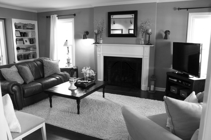 salon-noir-et-gris-sofa-cuir-cheminée-décorative-blanche 