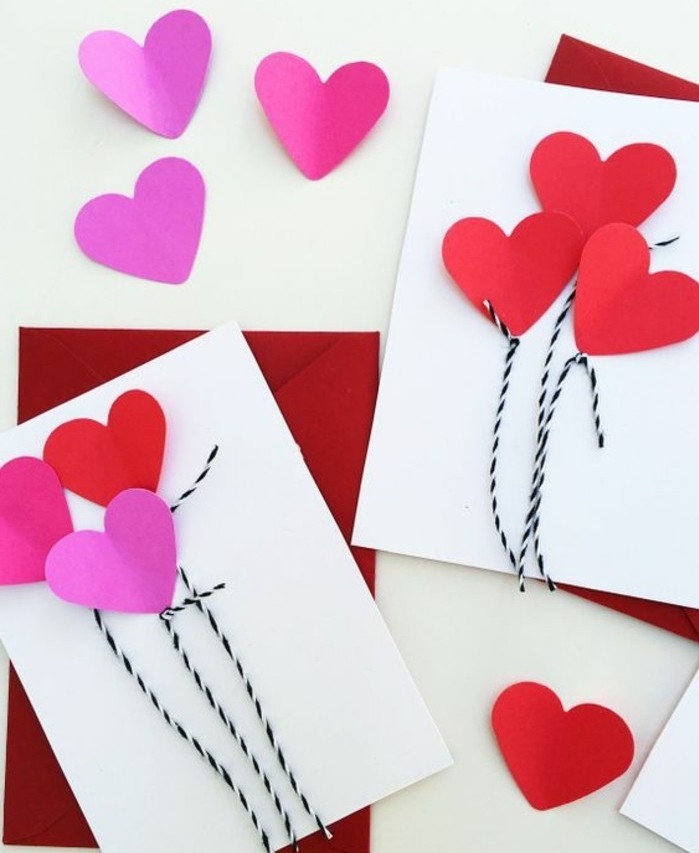 des coeurs rose et rouges sur un bout de feuille blanc, activité créative matenrelle à réaliser pour la Saint Valentin