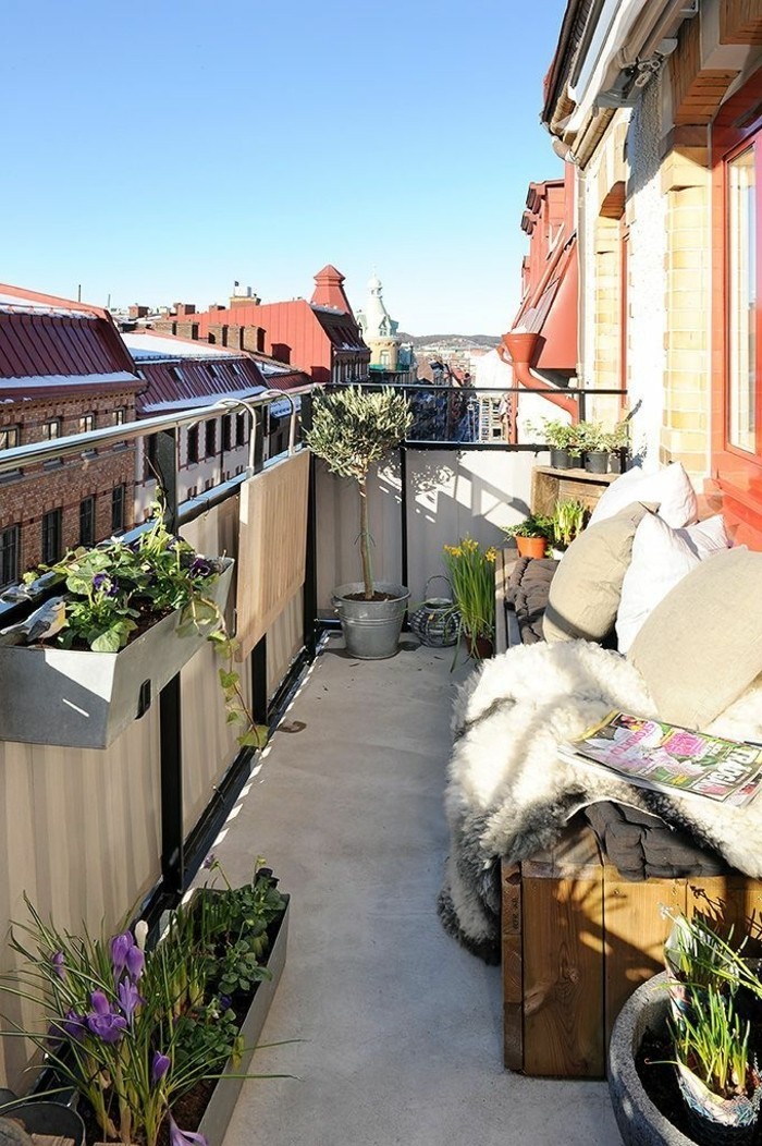 aménagement balcon, banc en bois, coussins blanc et beige, plantes vertes