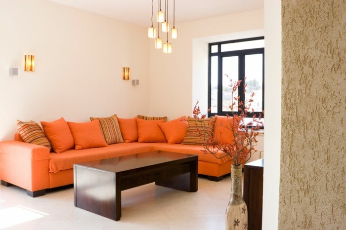 maison feng shui, canapé orange, lampes suspendues, table en bois foncée