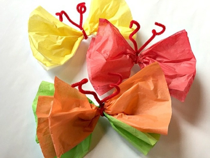 activité créative de maternelle, papillons en papier crépon, orange, rouge, vert et jaune, bricolage enfant 