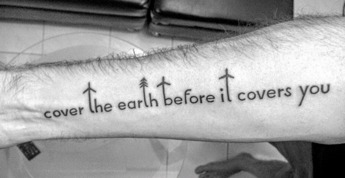tatouage symbole liberté ecriture sur le bras symbole voyage cover the earth before it covers you