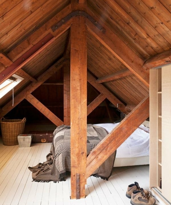 chambre mansardée, charpente, toiture en bois, poutres apparentes, parquet blanc, linge de lit blanc et couverture de lit grise