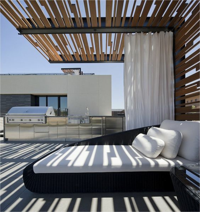 une pergola relaxant au design contemporain et une cuisine d'extérieur en acier chromé