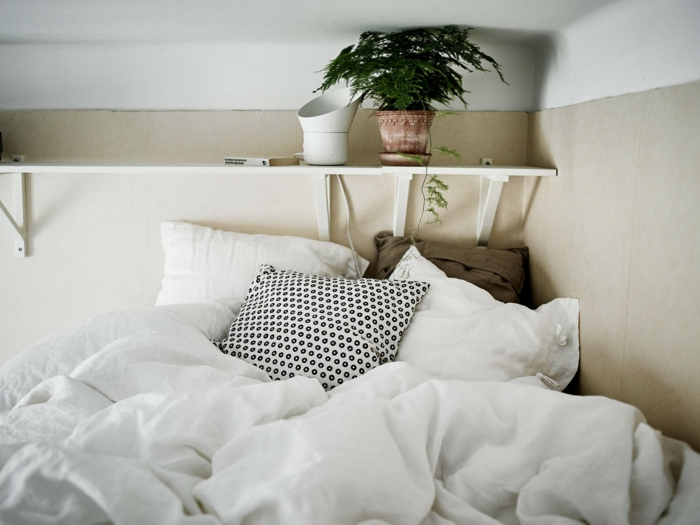 le nid douillet, plante verte, étagère murale en bois, oreillers blancs