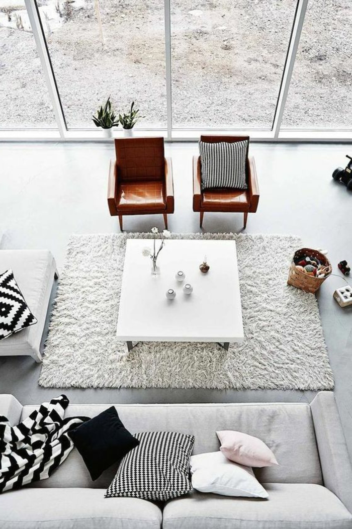 maison minimaliste, table carrée blanche et deux chaises en cuir, tapis rectangulaire