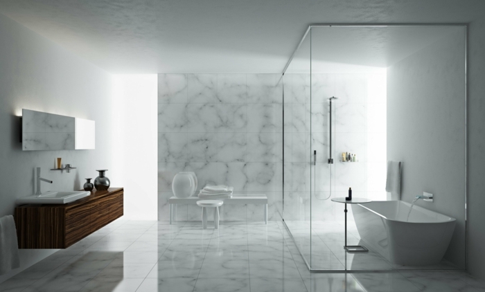 salle de bain en marbre, baignoire blanche, colonne de douche, vasque à encastrer, meuble sous vasque en bois, miroir rectangulaire