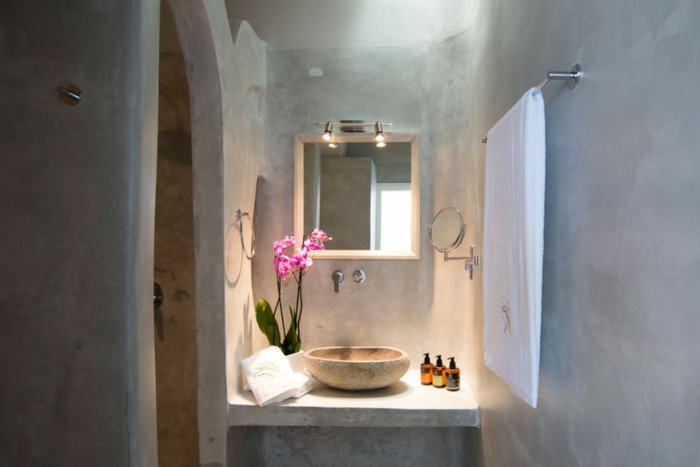 meuble en pierre grec, lavabo en marbre, arc, orchidée rose, salle de bain grecque