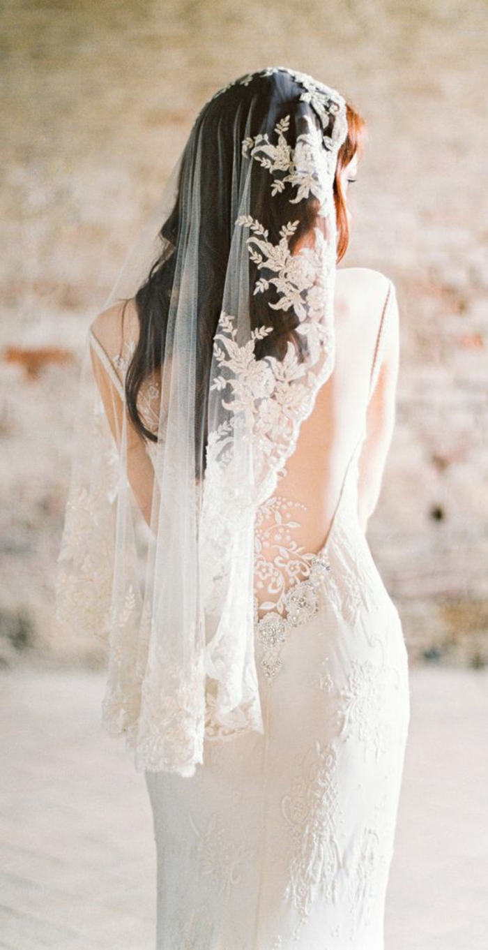 un voile de mariée traditionnel mantille associé à une robe élégante contemporaine à dos décolleté