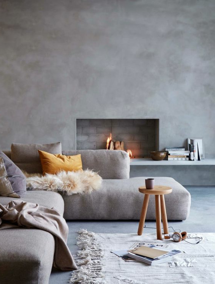 couleur assortie au gris, petit tabouret en bois, enduit mural gris, sofa bas