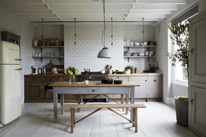 modele de cuisine, grand pot à fleur en béton, banc en bois, mur en briques peint en blanc, cuisine aménagée
