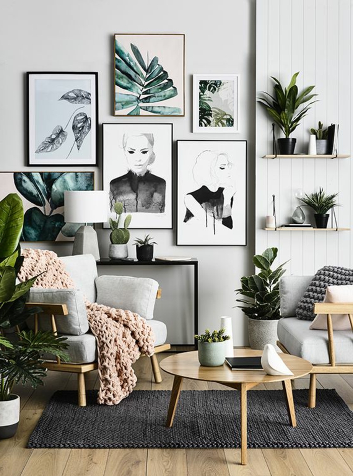 mur de cadres, parquet stratifié, plaid en crochet, lampe blanche, fauteuil blanc en bois, plantes vertes