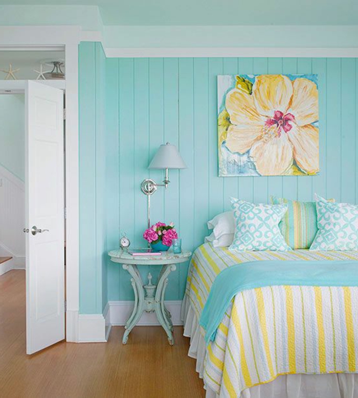 deco scandinave, mur lambris couleur bleu clair, table de nuit vintage bleue, tableau decoratif dessin fleur, linge de lit jaune, bleu et blanc