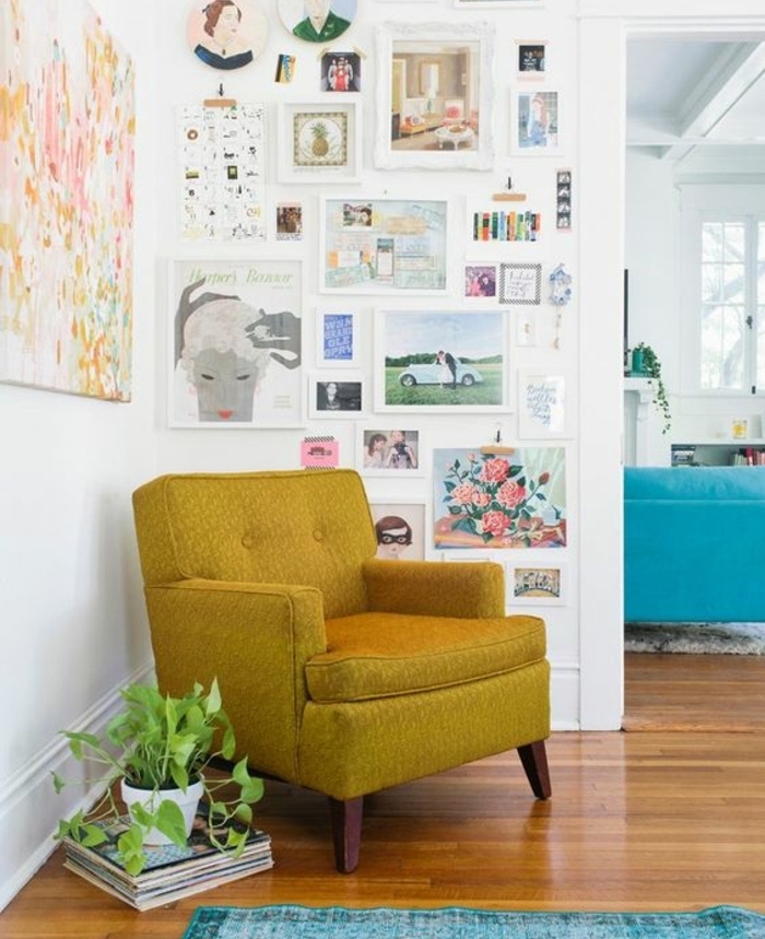 deco scandinave, fauteuil jaune ocre, tapis bleu turquoise, decoration murale de photos et dessins, plante verte, parquet marron