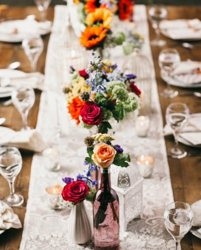 chemin de table en dentelle, idee deco mariage, des bouteilles en verre transformées en vases de fleurs, bouquets multicolores