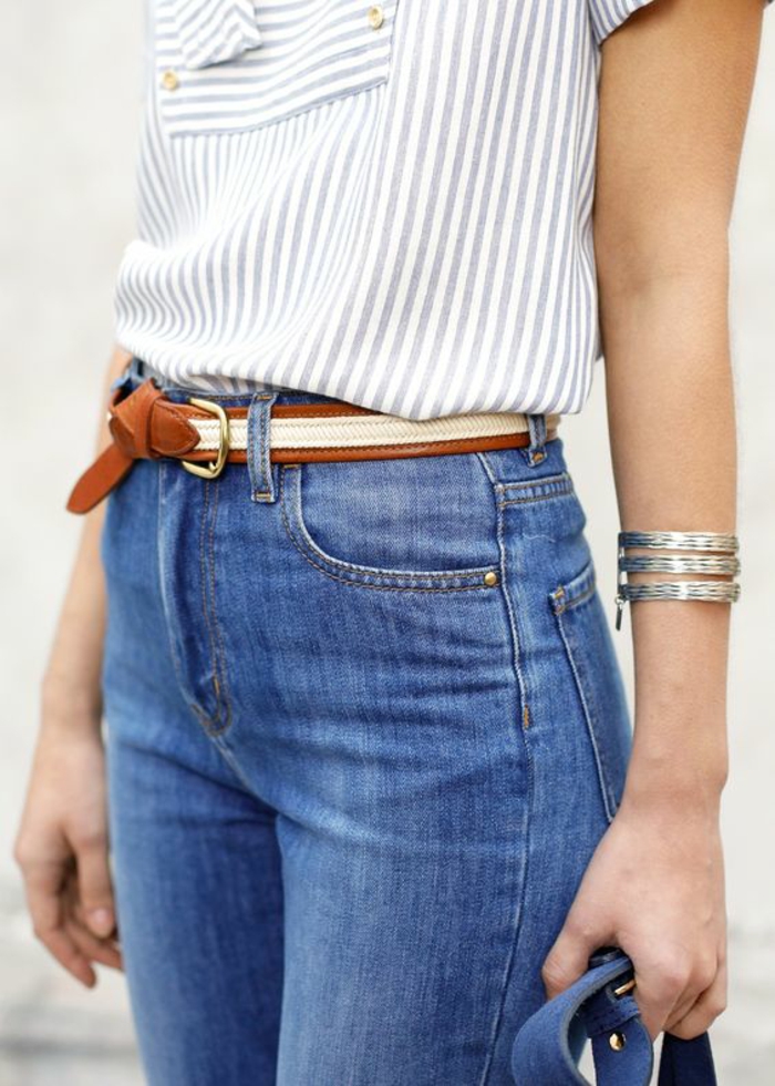 mode année 80 jean denim clair taille haute avec ceinture tressée en marron et blouse rayures bleu et blanc manches courtes