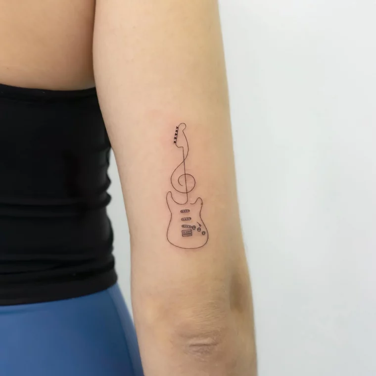 tatouage guitare lignes fines dessin bras femme musique