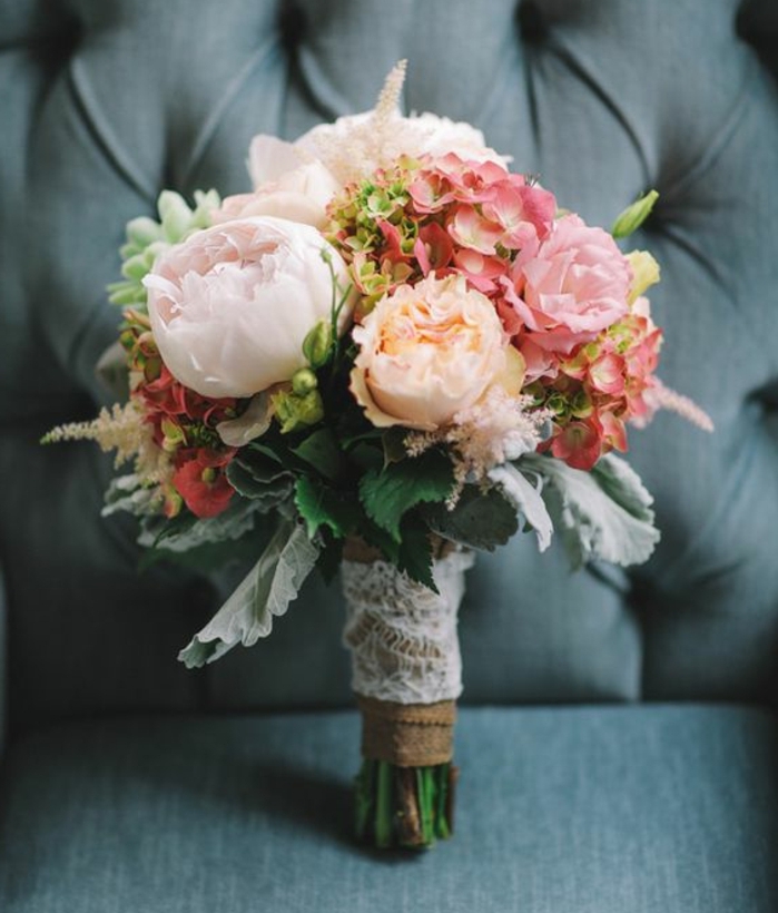 un bouquet de mariage pivoines et aures fleurs, tiges, serrés de dentelle blanche, idée décoration mariage