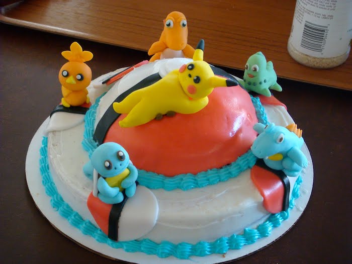 pikachu mignon, dessert fait maison, gâteau d anniversaire, figurine en pâte d'amande, table en bois, crème blanche