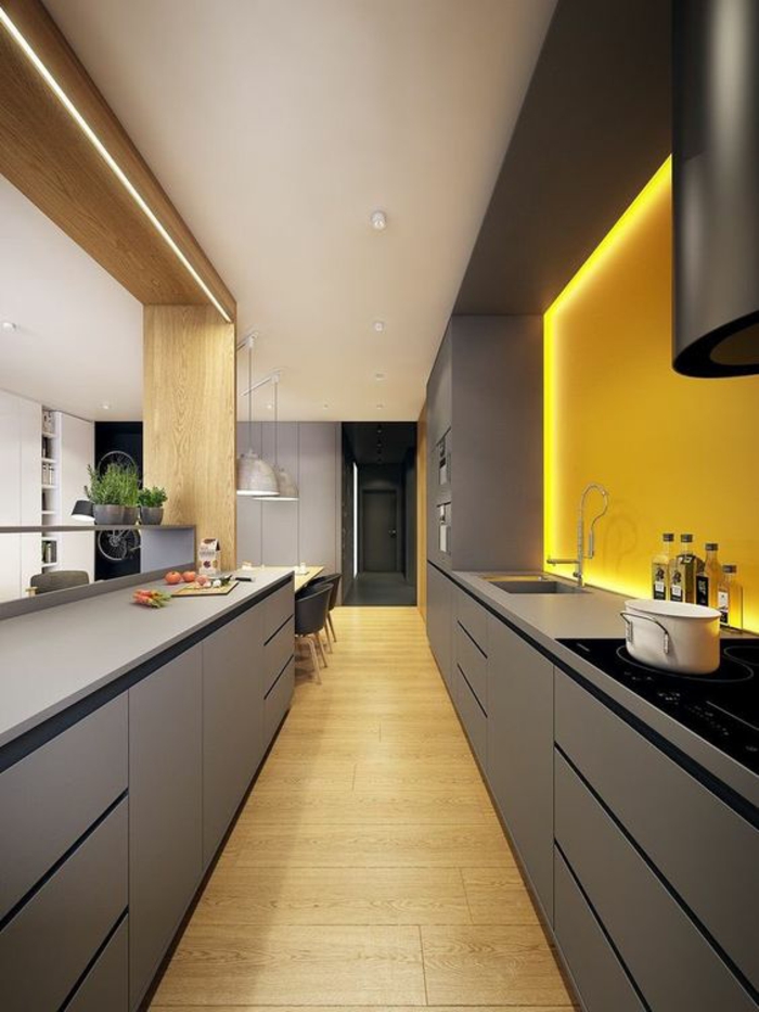 cuisine en noir avec une niche illuminée de lumière jaune plafond partiellement blanc et des accents imitation bois clair
