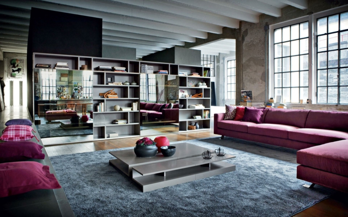 idee deco industrielle, coussins violets, grands miroirs, canapé d'angle, table basse grise, tapis moelleux, plafond avec poutres