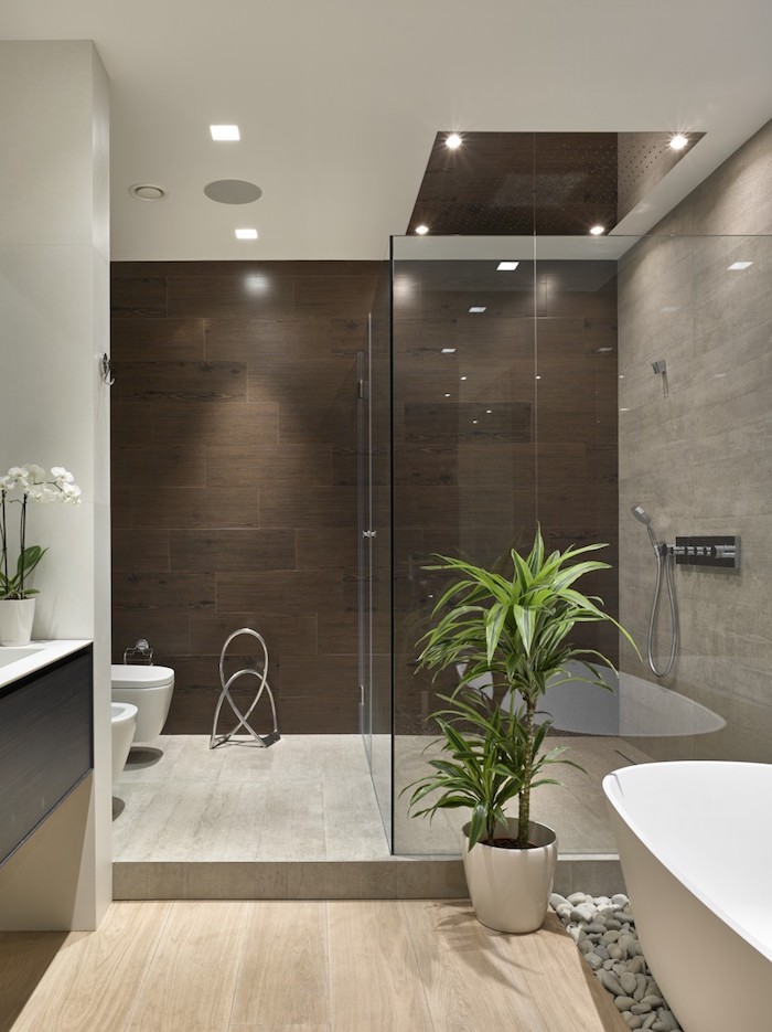 decoration salle de bain, meubles sous vasque noirs, orchidée blanche, plancher en bois, murs marron