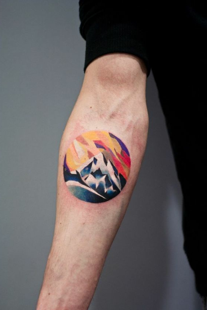 tatoo homme, tatouage rond montagne colorée, se faire un tatouage original