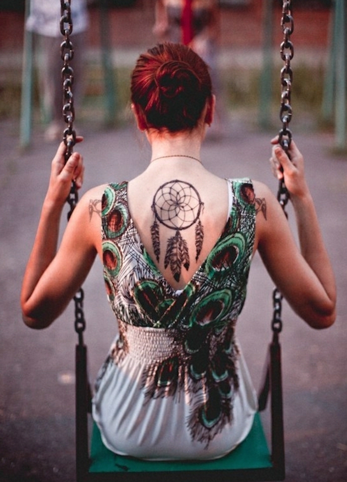 grand tatouage attrape reve sur le dos, cerceau, filet et plumes dessinés à l encre noire, femme aux cheveux rouges