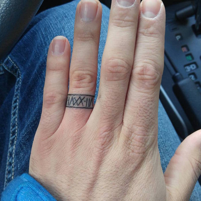 tatouage doigt date de naissance en chiffre romain style bague