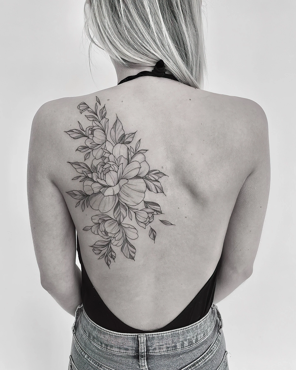 tatouage omoplates femme fleur grosse petales feuilles photo blanc et noir