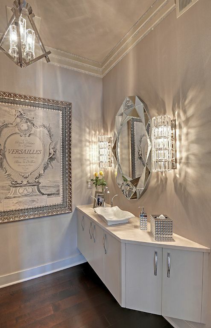 petite salle de bains au lustre et applique en crystal avec meuble suspendu en blanc