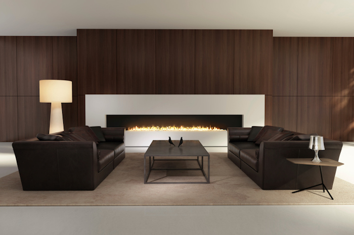 salon design couleur bistre marron avec canapés cuirs bruns et cheminée moderne grande