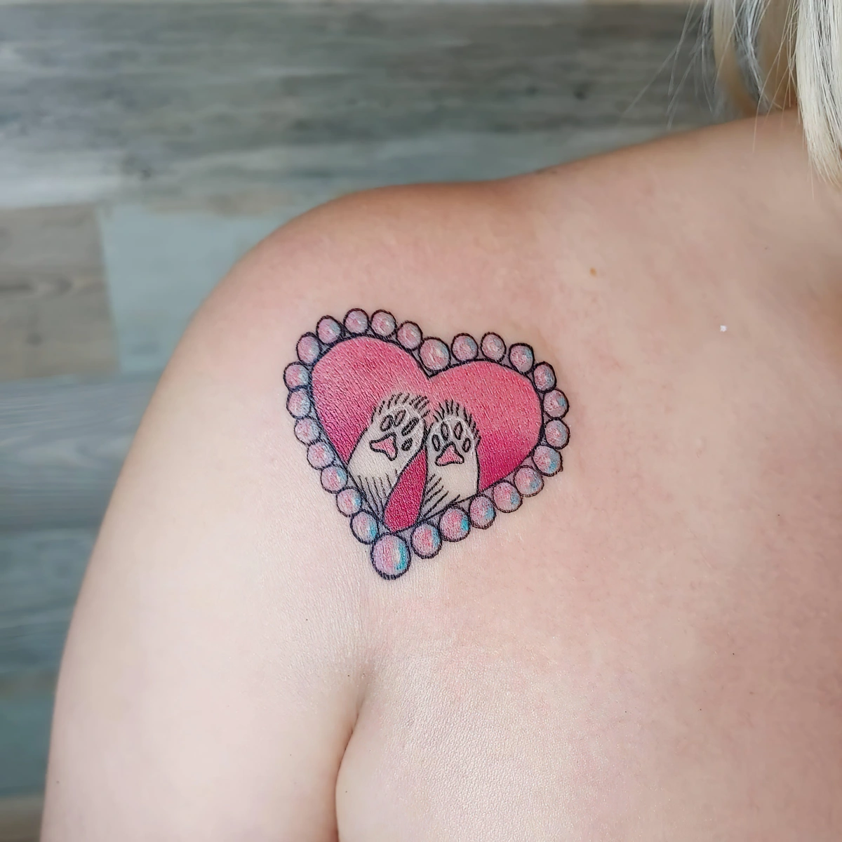 tatouage chat coeur rouge pattes amour idee dessin clavicule