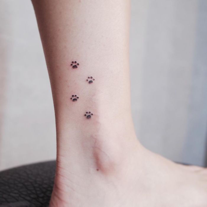 tatouage petits pas chiens sur la cheville discret mini pieds