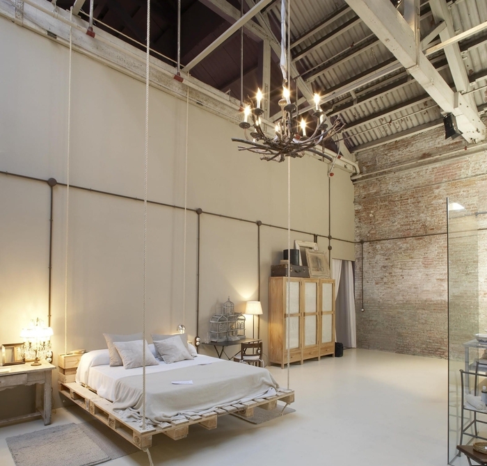 une chambre à coucher de style industriel d esprit loft avec un lit palette europe en suspensions 