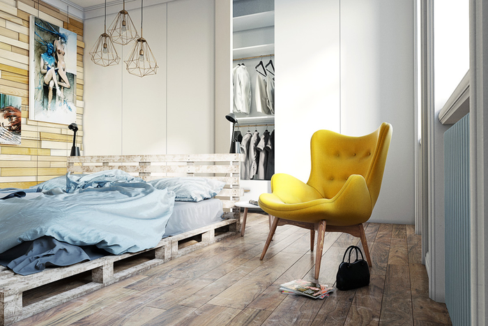 une chambre à coucher ensoleillée de style scandinave qui respire la tranquillité et la sérénité grâce au lit palette en bois, le mur en lambris et le parquet