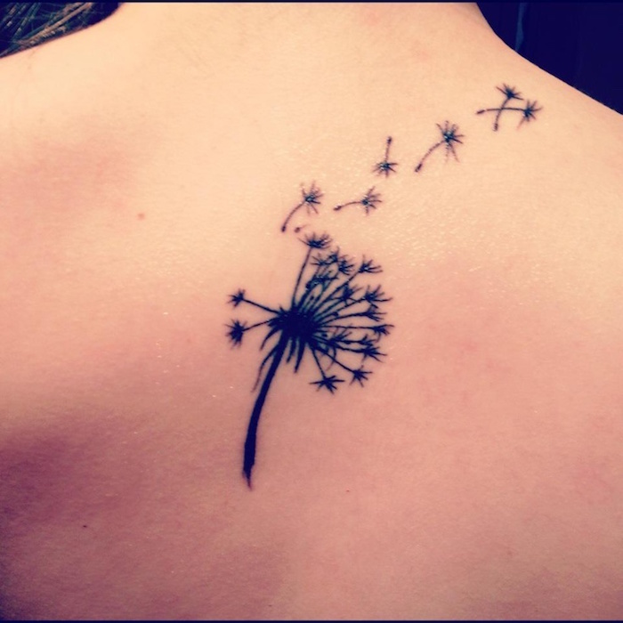 tatouage fleur dans le dos style pissenlit volant