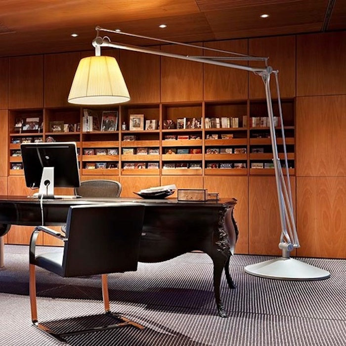 espace de travail avec bureau baroque et chaise moderne, grande lampe design et meuble en bois clair