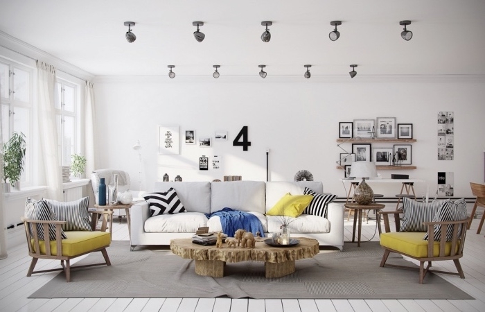 deco salon scandinave, tapis gris, canapé blanc cassé, chaises en bois avec coussins d assise jaune, table bois rustique, deco murale de dessins et photographies en noir et blanc