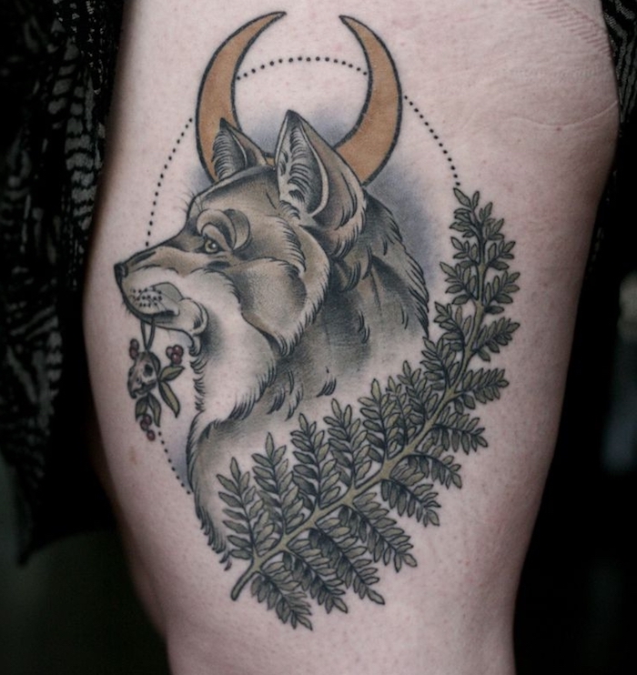 signification tatouage, art corporel pour femme, tattoo en couleurs sur jambe à design loup