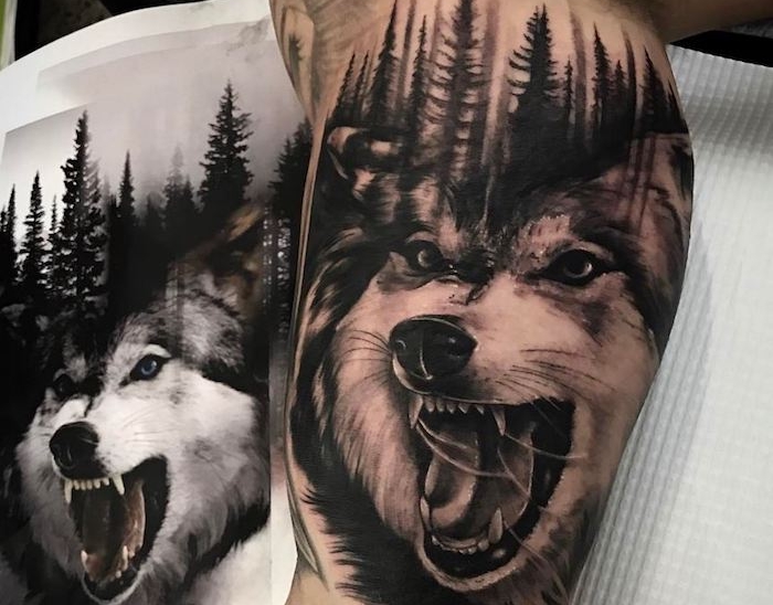 tatouage bras homme, dessin sur la peau à design loup féroce et paysage de forêt