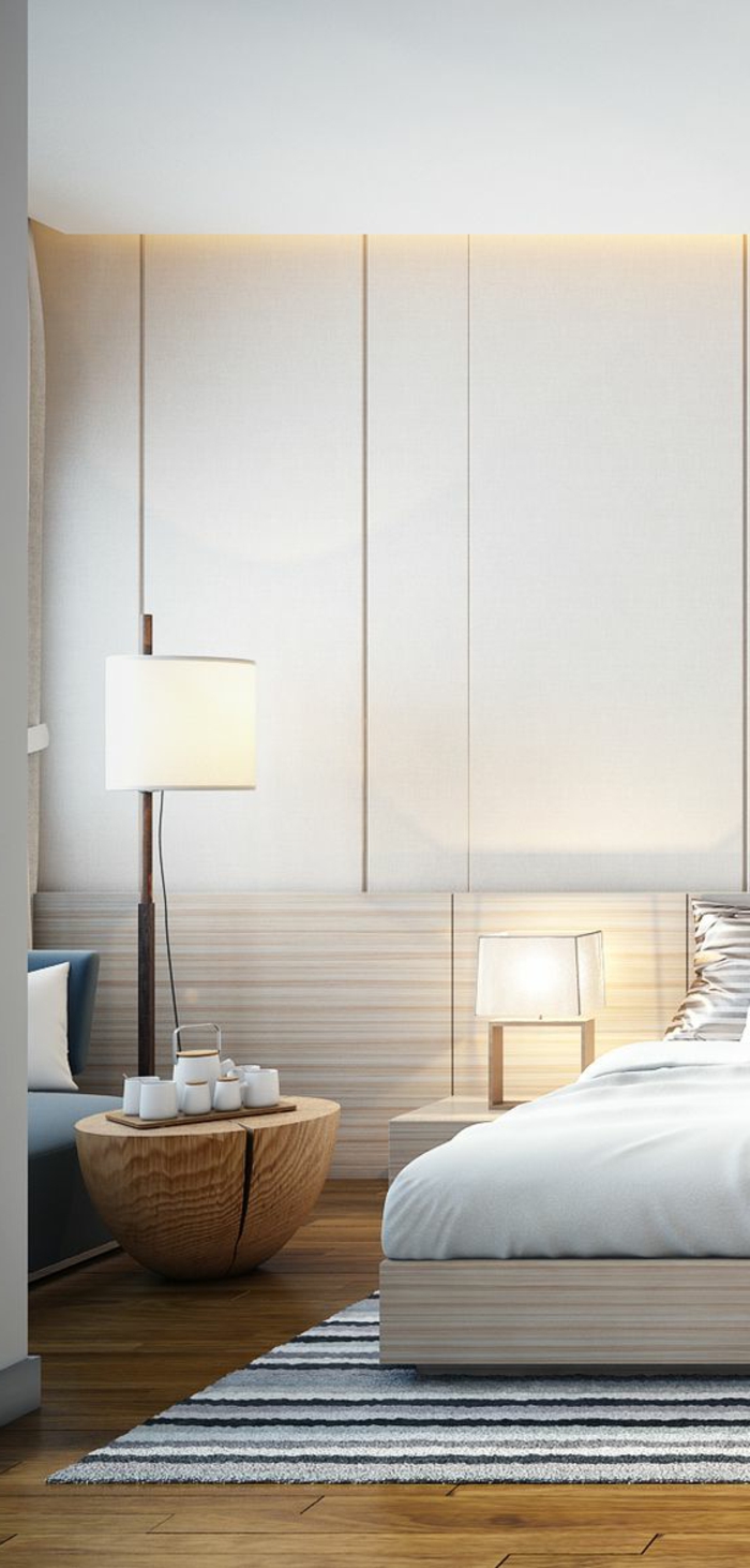 idee deco chambre avec meuble table basse en forme de tronc d arbre chambre au plafond haut avec un tapis rectangulaire sous le lit en bleu blanc et beige