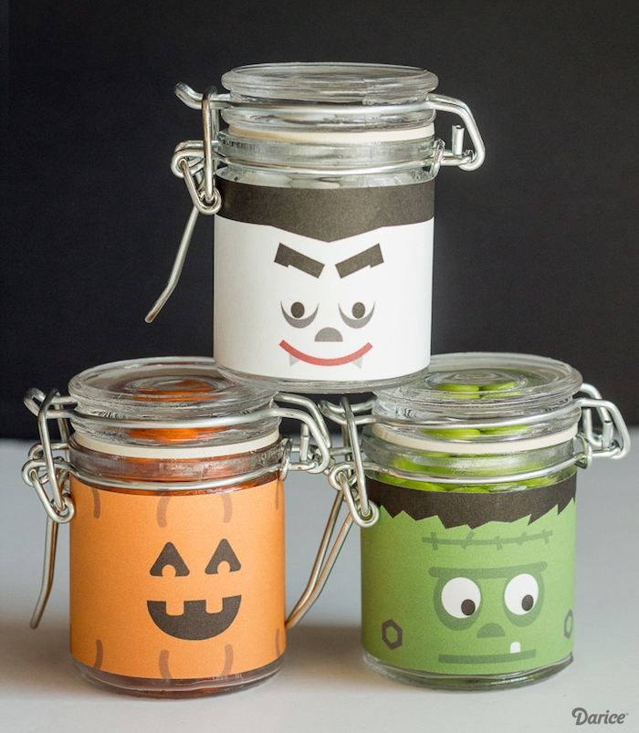 activité halloween avec des pots en verre, décorés de papier avec des visages monstre, vampire e jack o lanterne, bougeoir halloween
